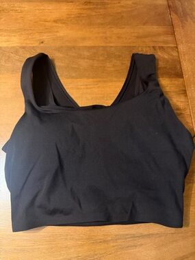 New with Tags Black Scoop Neck Sports Bra with open stripe back.